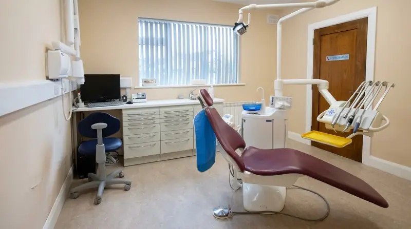 A treatment room at Westside Dental with a burgundy dental chair